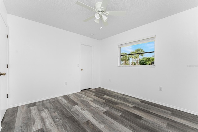 unfurnished room with ceiling fan, dark wood-type flooring, and a textured ceiling