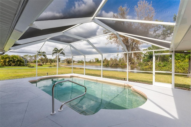 view of swimming pool with glass enclosure, a yard, and a patio