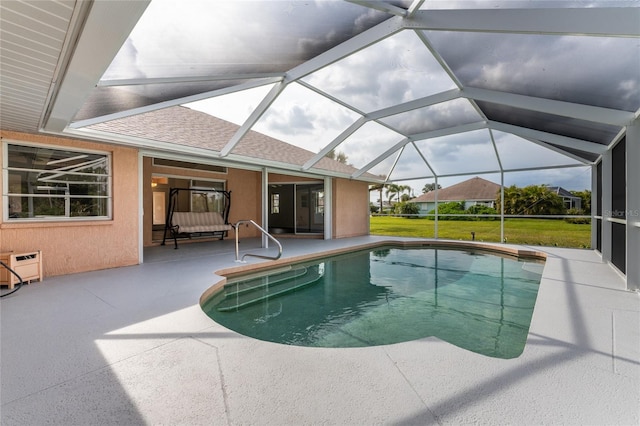 view of pool with a yard, a patio, and a lanai