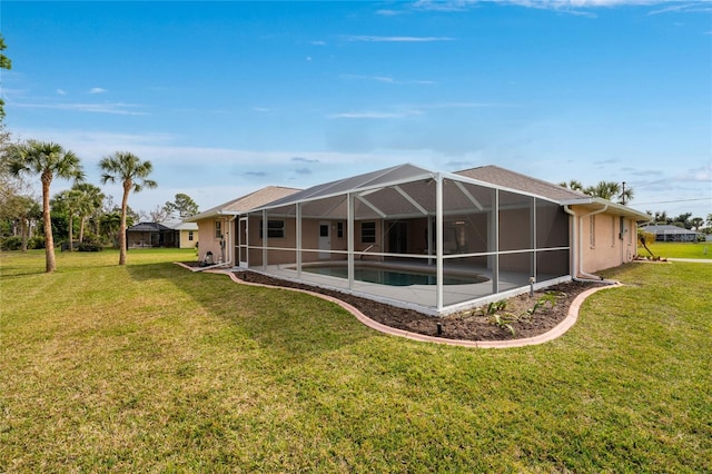 back of property featuring a lawn and a lanai