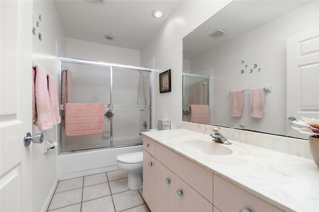 full bathroom featuring tile patterned flooring, vanity, toilet, and enclosed tub / shower combo