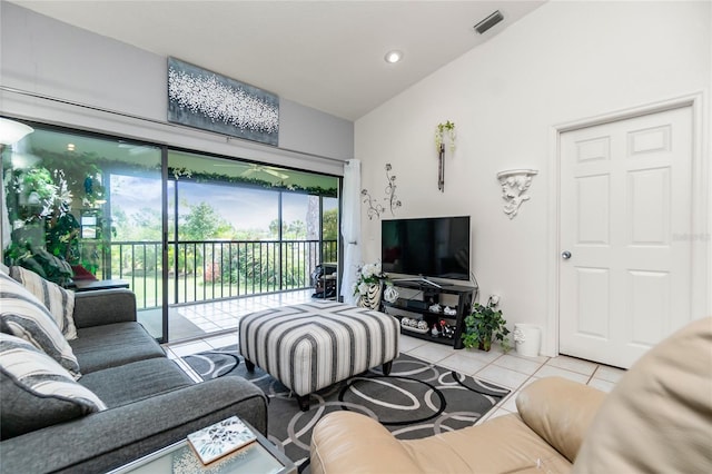 living room with light tile patterned flooring and vaulted ceiling