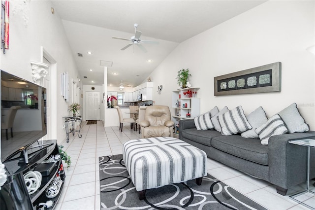 tiled living room featuring ceiling fan and lofted ceiling