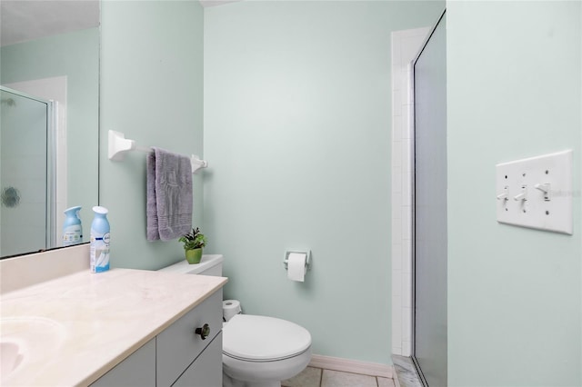 bathroom featuring tile patterned flooring, vanity, toilet, and a shower with shower door