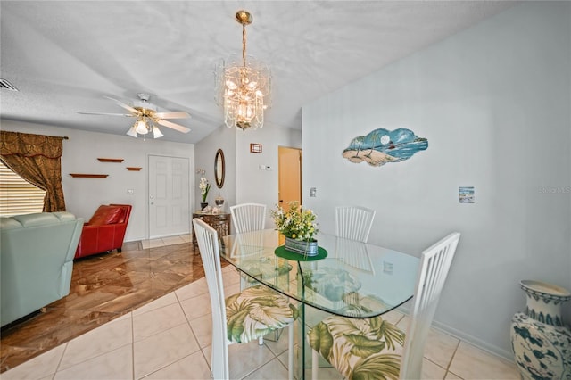 dining area featuring a textured ceiling, ceiling fan with notable chandelier, and light tile floors