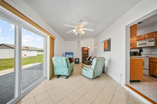 tiled living room with ceiling fan