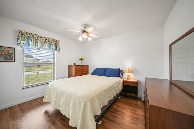 bedroom featuring a textured ceiling, ceiling fan, and dark hardwood / wood-style flooring