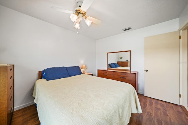 bedroom with ceiling fan and dark wood-type flooring