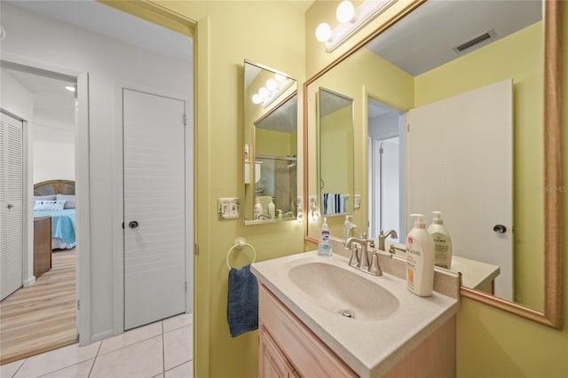 bathroom with tile flooring and large vanity