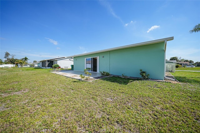 back of house featuring a yard and a patio