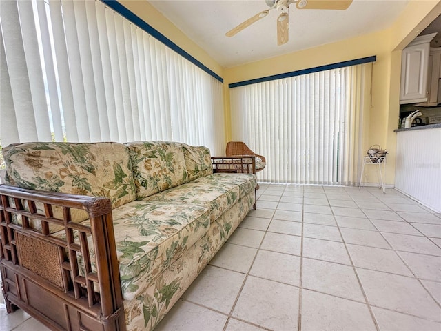 living room with ceiling fan and light tile patterned floors