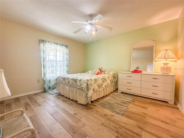 bedroom with ceiling fan and light wood-type flooring