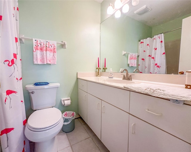 bathroom with tile patterned flooring, vanity, walk in shower, and toilet