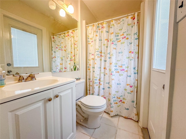 bathroom featuring tile patterned flooring, vanity, and toilet