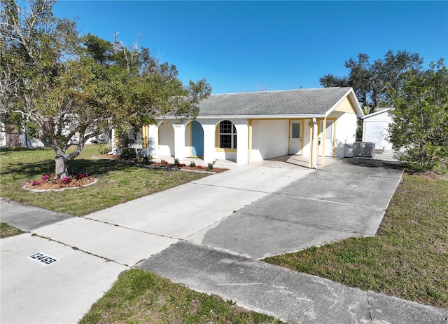 ranch-style home featuring a carport and a front lawn