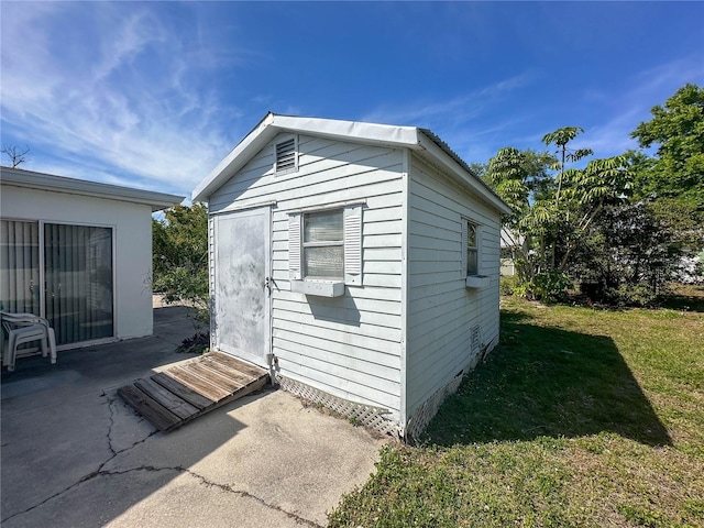 view of outbuilding featuring a yard