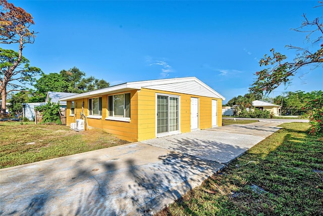 view of property exterior with a yard