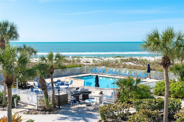 view of swimming pool with a water view and a patio area