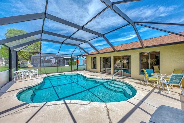 view of swimming pool featuring a patio area and a lanai