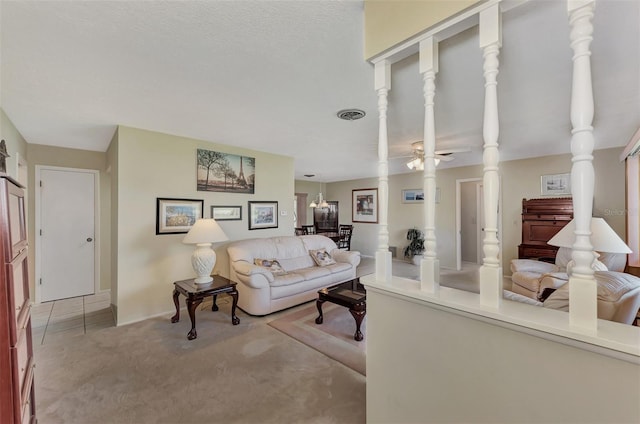 carpeted living room with ceiling fan