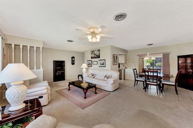 carpeted living room with ceiling fan