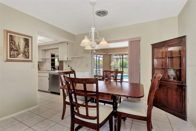 dining room with a chandelier and light tile floors