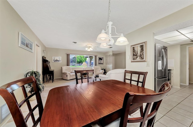 tiled dining room featuring an inviting chandelier