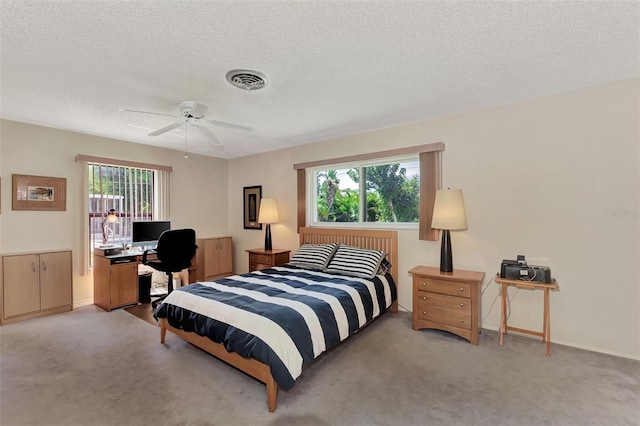 bedroom with light colored carpet, ceiling fan, and multiple windows