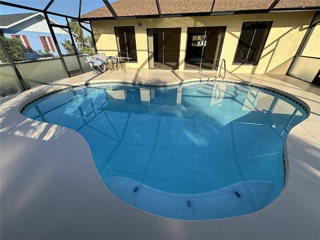 view of swimming pool with a lanai