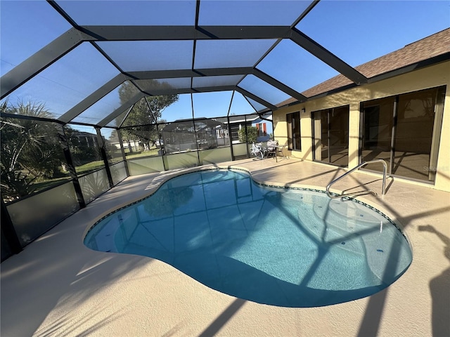 view of swimming pool featuring a patio area and glass enclosure