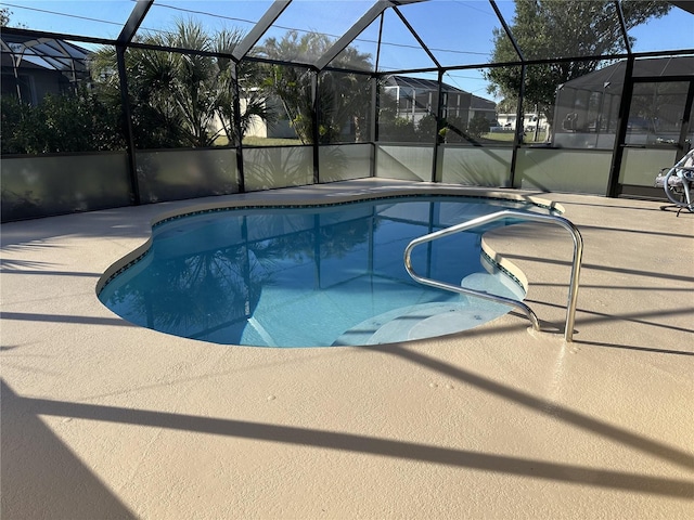 view of pool with a patio area and a lanai