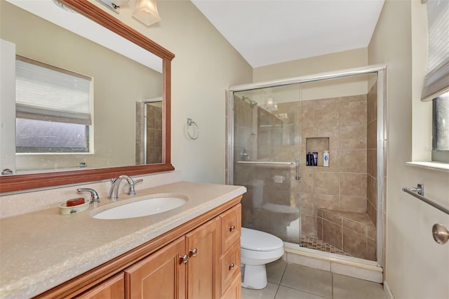 bathroom with tile patterned floors, toilet, vanity, and a shower with shower door