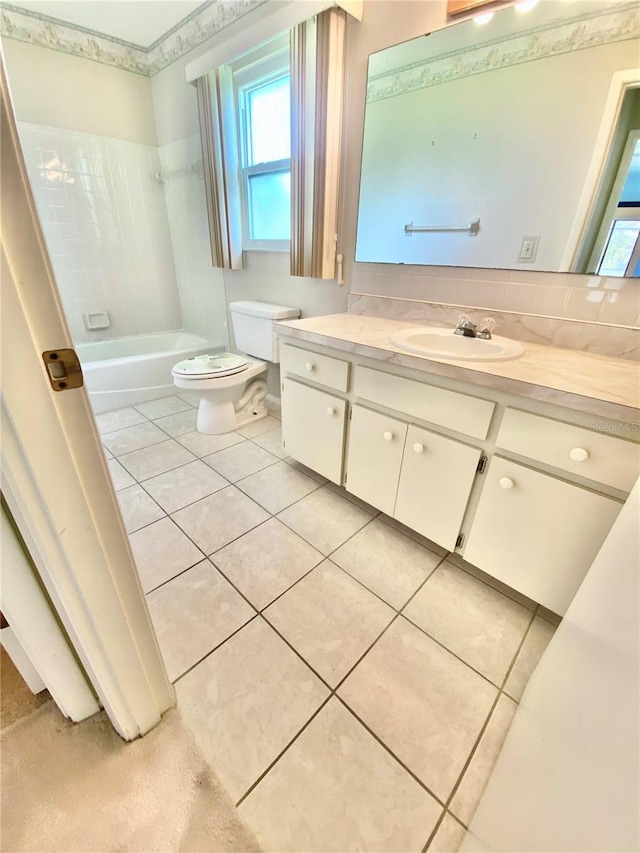 full bathroom featuring tile patterned floors, toilet, vanity, and tiled shower / bath