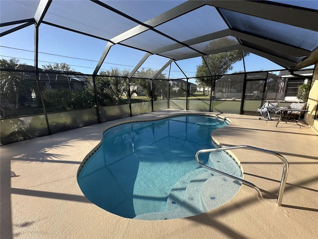 view of pool with a patio area and a lanai