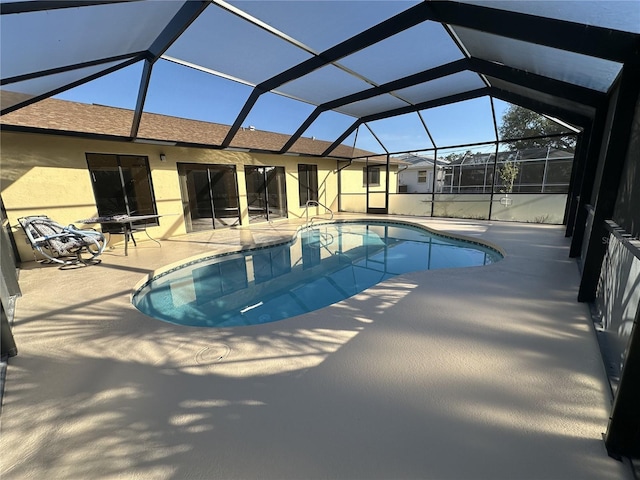 view of swimming pool featuring a patio, a lanai, and a fire pit