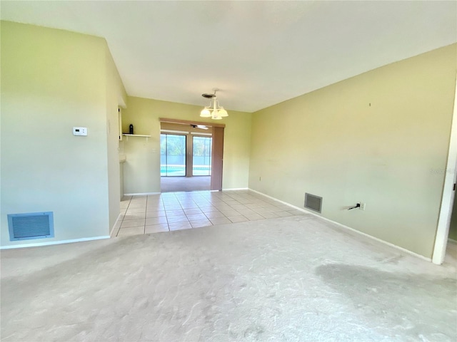 unfurnished room featuring light tile patterned floors and a notable chandelier