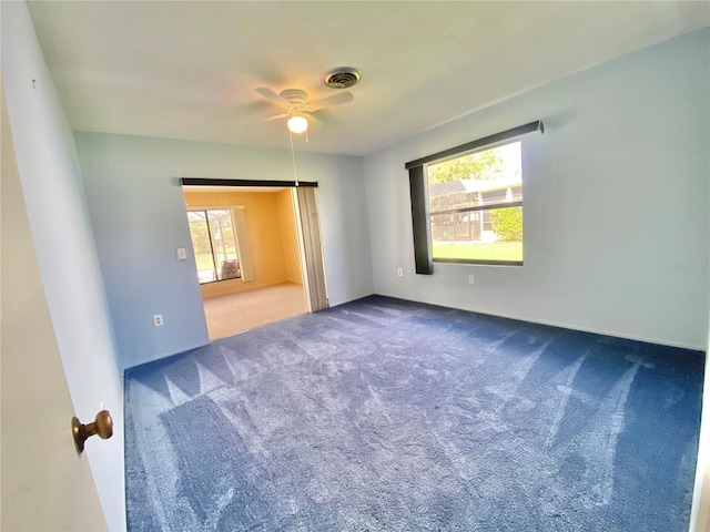 unfurnished room with ceiling fan and carpet flooring