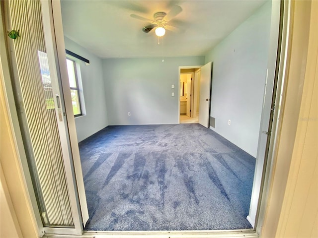 carpeted empty room with ceiling fan