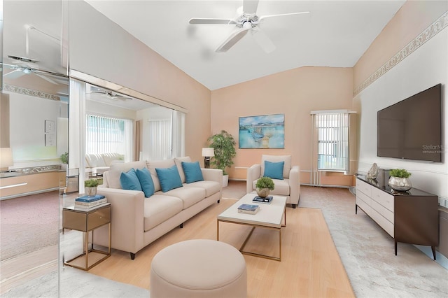 living room featuring lofted ceiling, ceiling fan, and light wood-type flooring