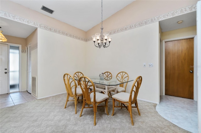 dining room with carpet and an inviting chandelier