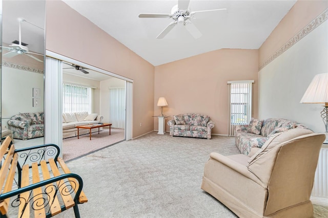 carpeted living room featuring vaulted ceiling and a wealth of natural light