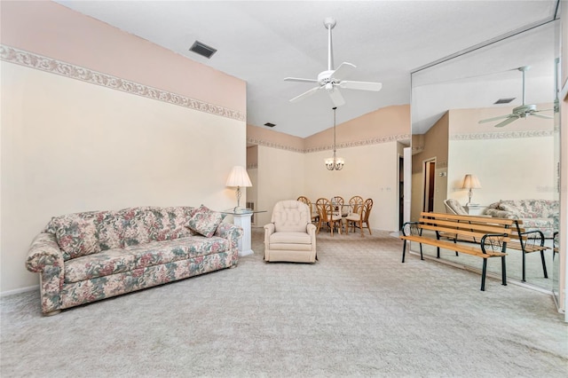 carpeted living room with ceiling fan with notable chandelier and lofted ceiling