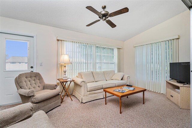 living room with light colored carpet, vaulted ceiling, and ceiling fan