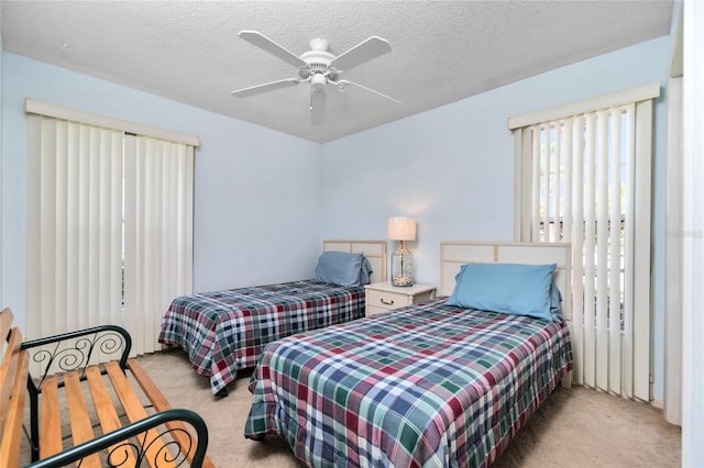 bedroom with light carpet, a textured ceiling, and ceiling fan