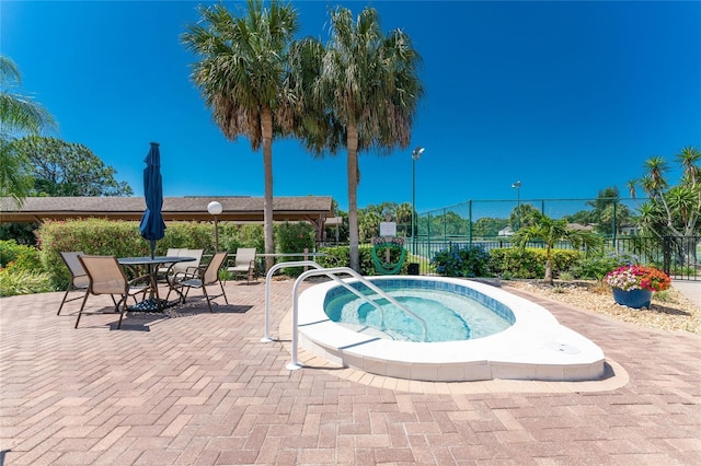 view of swimming pool with an in ground hot tub and a patio