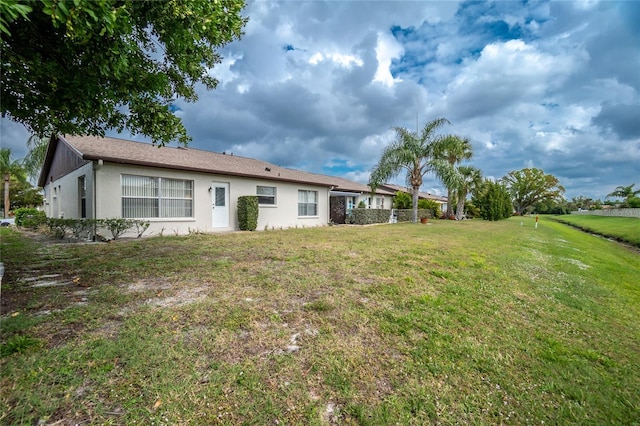 back of house featuring a yard