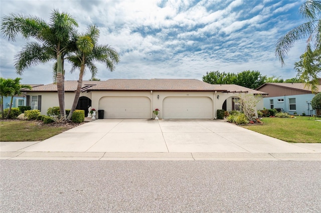 view of front of home featuring a front lawn and a garage