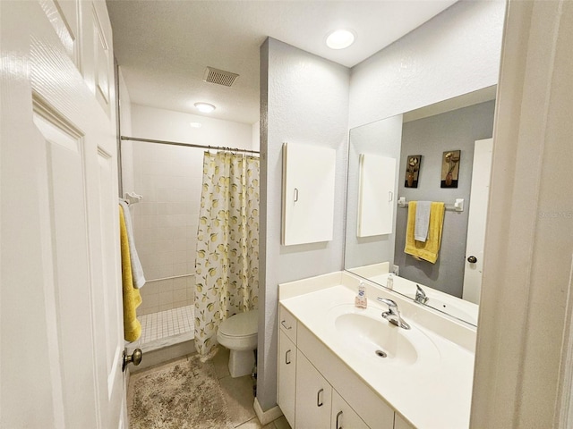 bathroom featuring a shower with shower curtain, vanity, toilet, and tile patterned floors