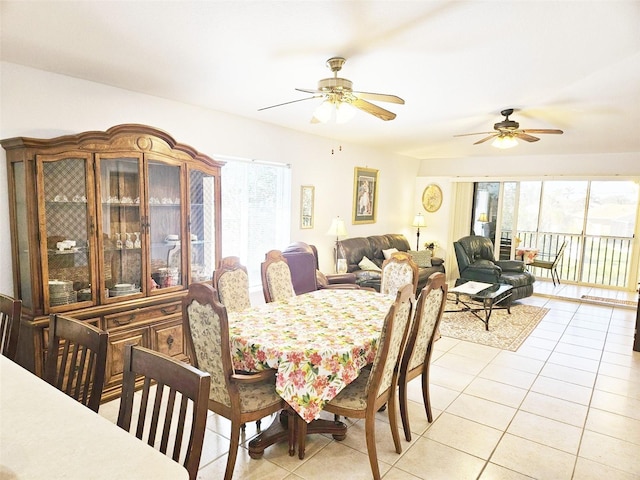 dining area with light tile patterned floors, plenty of natural light, and ceiling fan