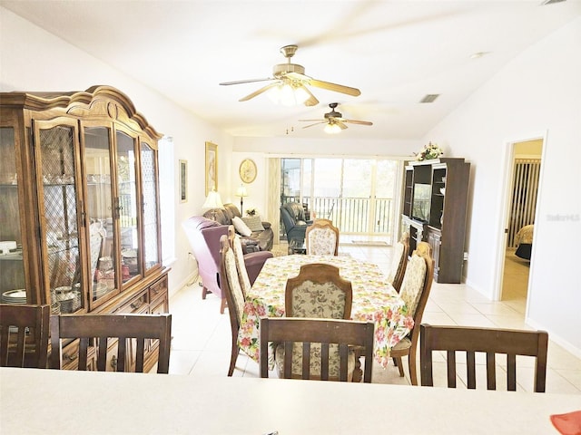 dining room with light tile patterned floors, ceiling fan, and lofted ceiling